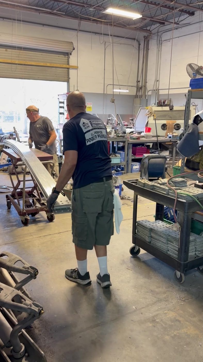 Southern Switch crew cleaning and preparing generator bus bar sections in the Palm Harbor shop during the generator bus refurbishment project.