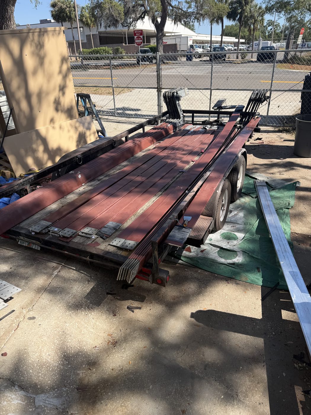 Flatbed trailer loaded with generator bus bar sections arriving at Southern Switch Palm Harbor shop, aged brown Raychem insulation visible, ready for strip and refurbishment.
