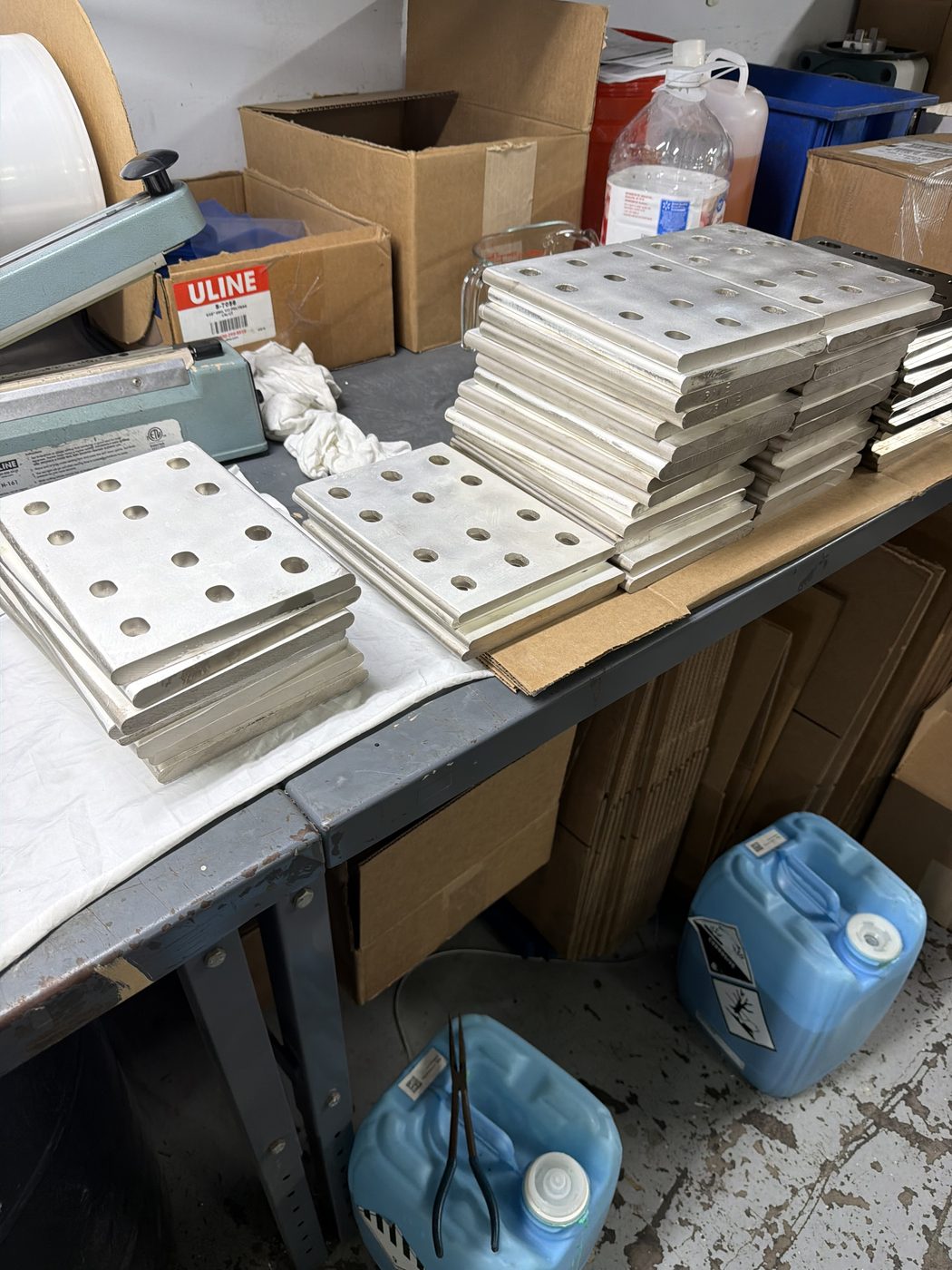 Stacks of silver-plated aluminum splice plates for generator bus, freshly replated at Southern Switch shop in Palm Harbor, FL.