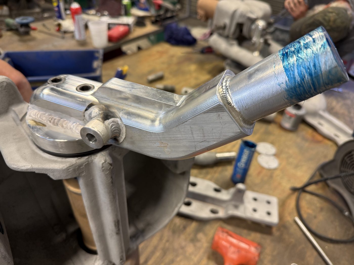 New billet aluminum operating arm being fitted to Southern States EV1 pivot housing at Southern Switch machine shop, fresh machining visible with layout dye on shaft.