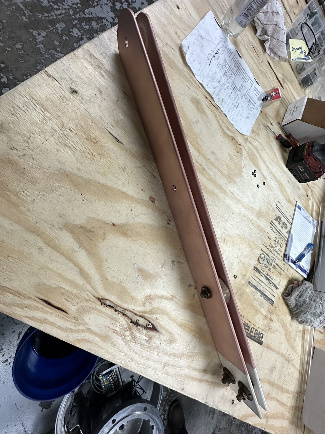 Fully refurbished utility disconnect switch blade arm on the workbench at Southern Switch, cleaned copper arm with silver contacts installed and all hardware replaced.