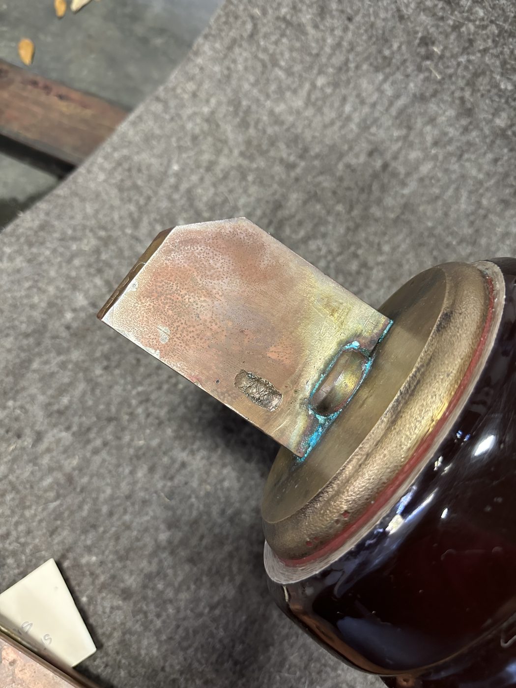Close-up of utility disconnect switch stationary contact terminal with blue-green solder corrosion buildup from repeated failed repairs.