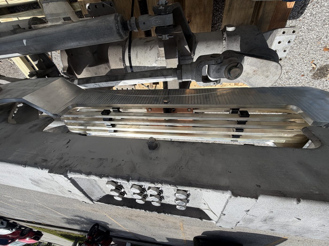 Close-up of rebuilt 500 kV pantograph switch contact assembly, new aluminum jaw with copper finger contacts, ready for reassembly.