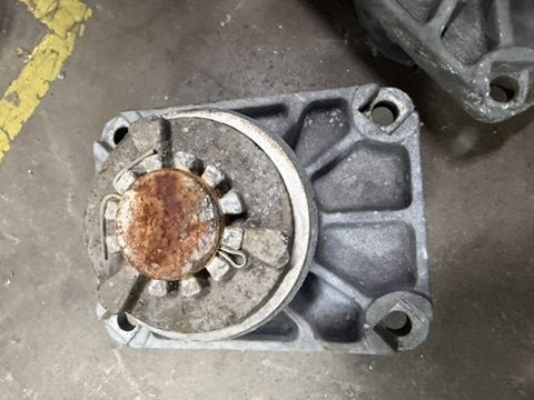 As-received Southern States EV2 bearing on its mounting flange, the aluminum housing and lock nut bloomed white with corrosion and the steel shaft end rusted at the center