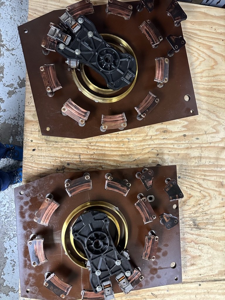 Worn stationary contacts on two GE T875 voltage regulator boards as received, showing erosion and discoloration on the copper contact faces.