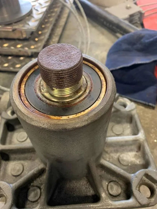 Bottom view with the lock nut removed, rust and pitting across the shaft, with corrosion along the outer edge of the bearing.
