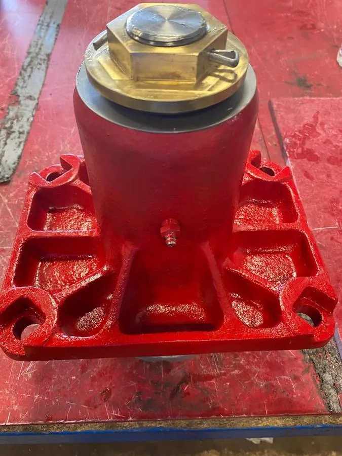 Bottom view, brass lock nut with locking cotter pin, stainless washer, and the added zerk fitting. Bearings and housing are packed with Mobil XHP222 grease.