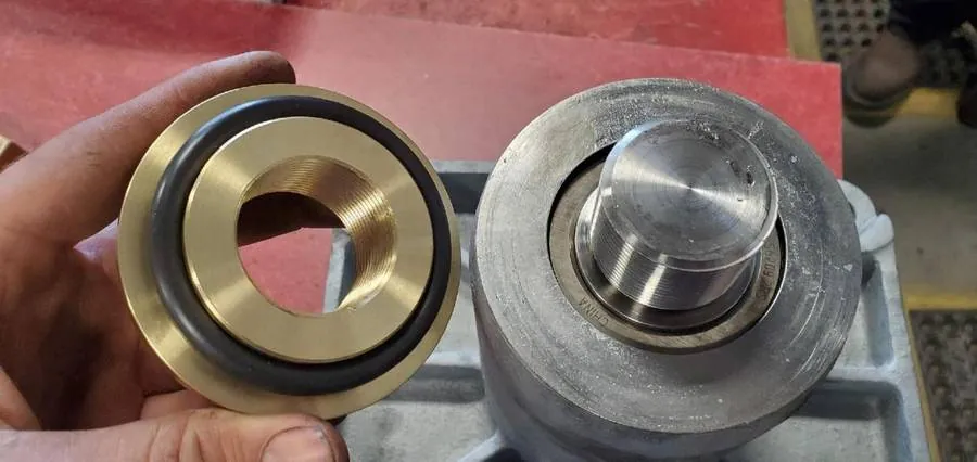 Machined brass lock nut and Viton O-ring alongside the rebuilt shaft. Standard steel bearings are replaced with sealed stainless-steel bearings.