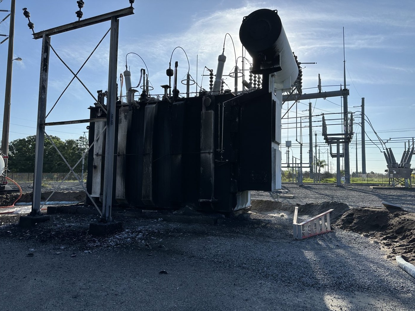 A 230 kV autotransformer after catastrophic thermal failure, severe fire damage to the tank and external components. Southern Switch was called in to remove the failed unit and install a replacement.
