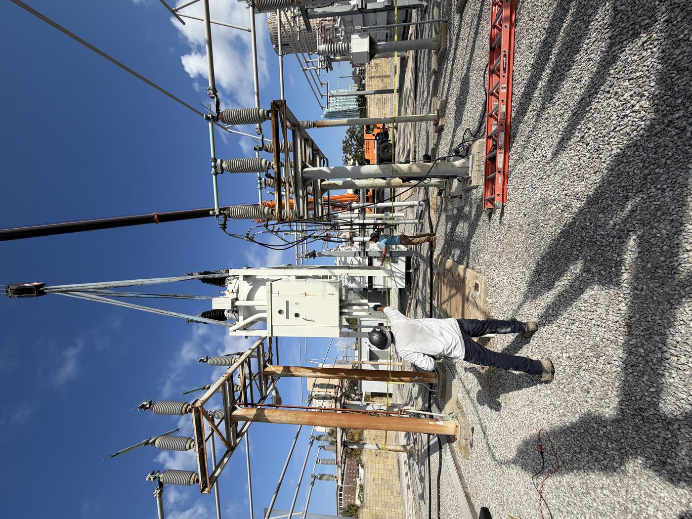 Old oil circuit breaker being lifted by crane out of a downtown substation during removal. Southern Switch crew directing the lift.