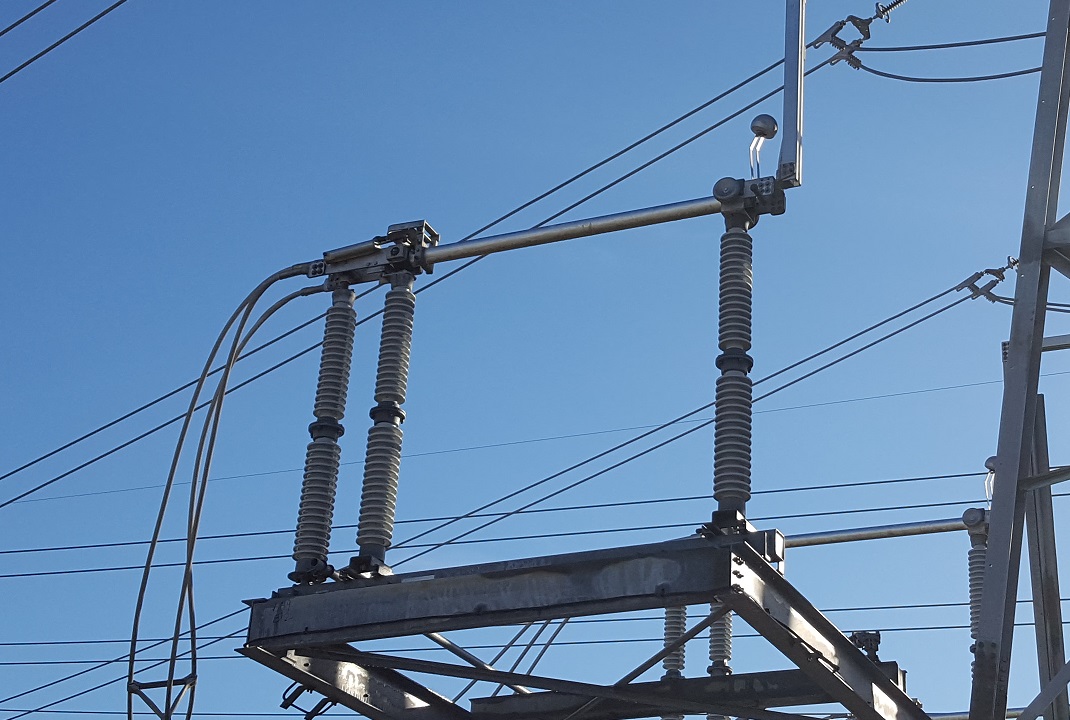 230 kV gang-operated disconnect switch in closed position at substation