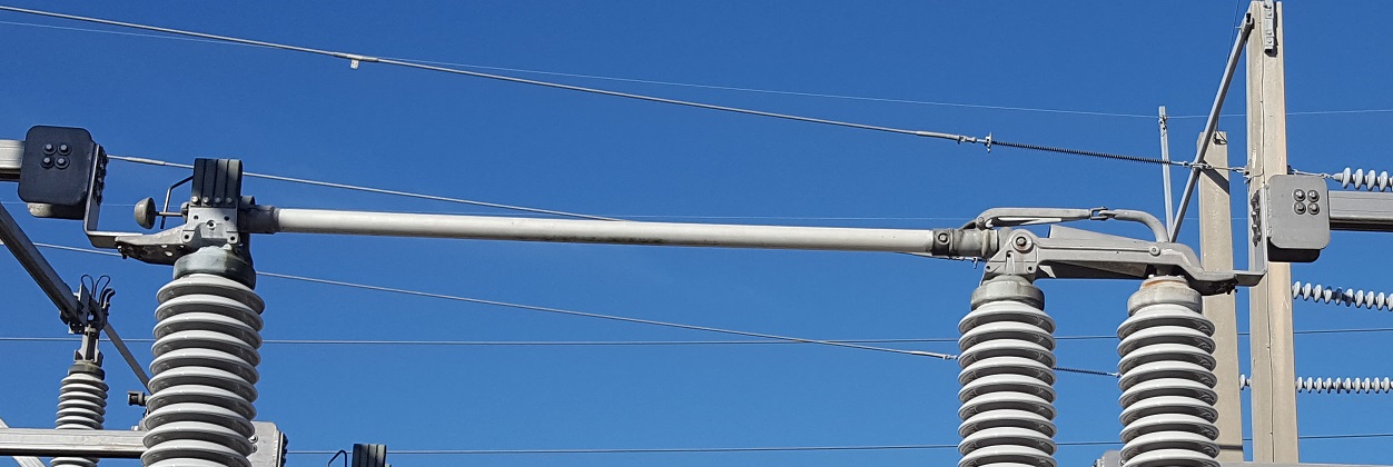 230 kV gang-operated disconnect switch in open position showing blade travel